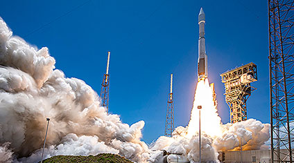 Car in front of clean energy fueling station.